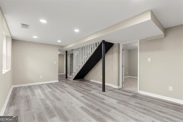 basement with light hardwood / wood-style floors