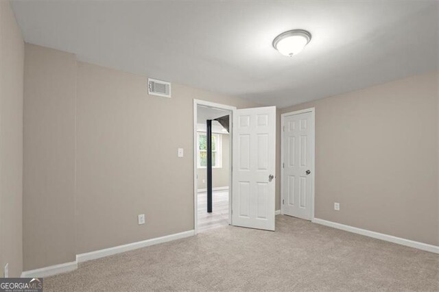 unfurnished bedroom featuring light carpet