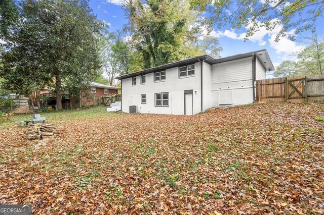 rear view of house with central AC unit