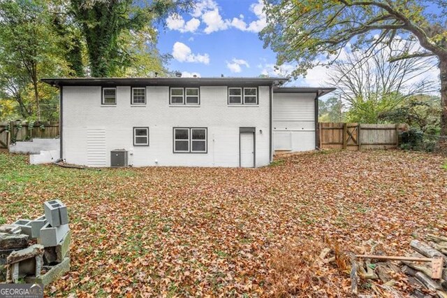 rear view of property with cooling unit