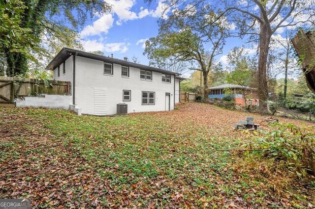 back of property featuring central AC