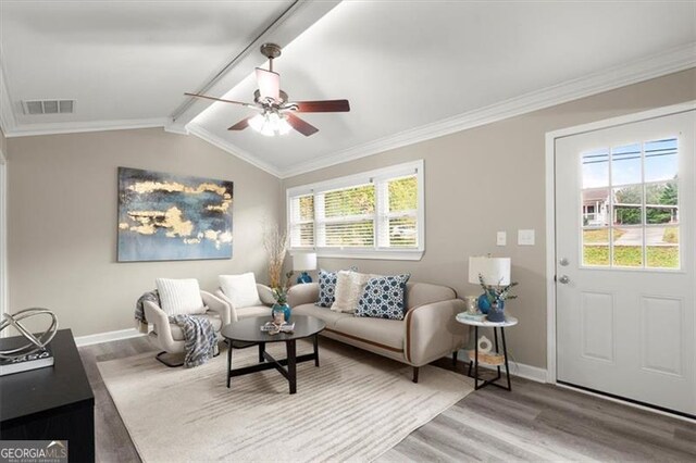 living room with lofted ceiling with beams, wood-type flooring, and a wealth of natural light