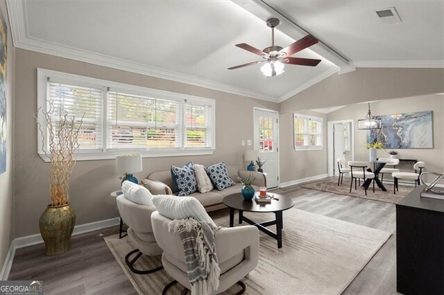 living room featuring vaulted ceiling with beams, hardwood / wood-style flooring, and a wealth of natural light