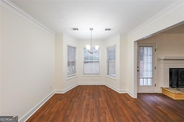 unfurnished dining area with dark hardwood / wood-style flooring, ornamental molding, and a notable chandelier