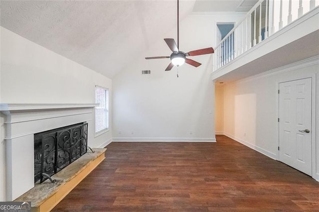 unfurnished living room with ceiling fan, dark hardwood / wood-style flooring, a textured ceiling, and high vaulted ceiling