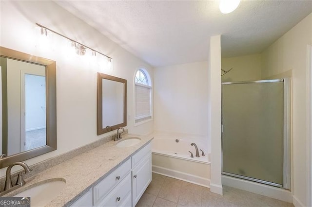 bathroom featuring tile patterned flooring, a textured ceiling, vanity, and independent shower and bath