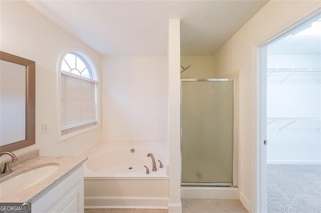 bathroom with vanity and independent shower and bath