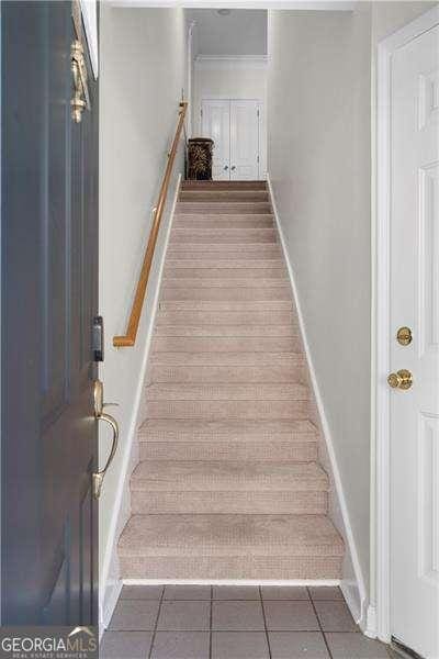 stairway with tile patterned floors