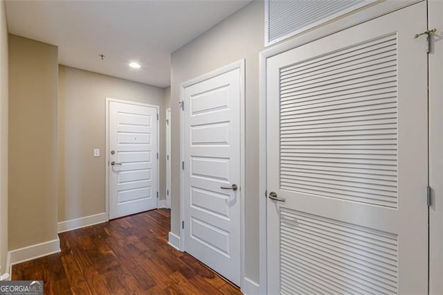 hallway with dark hardwood / wood-style flooring