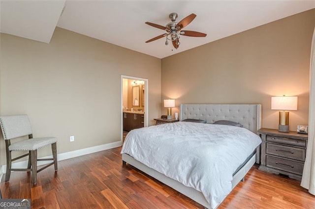 bedroom with ensuite bath, ceiling fan, and hardwood / wood-style flooring