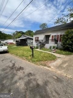 bungalow-style house with a front yard