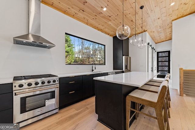 kitchen with pendant lighting, high quality appliances, wooden ceiling, wall chimney range hood, and a barn door