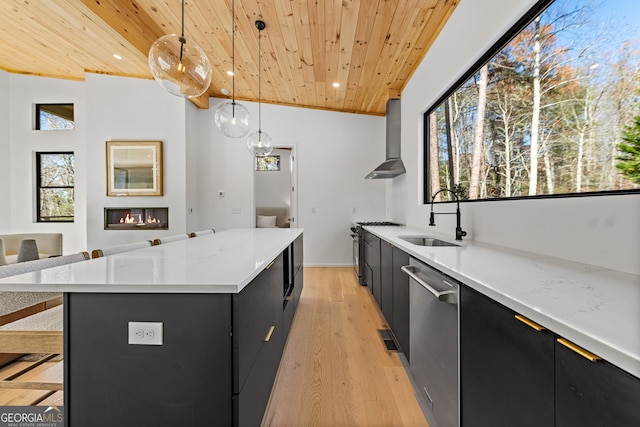 kitchen with sink, hanging light fixtures, wooden ceiling, and wall chimney range hood