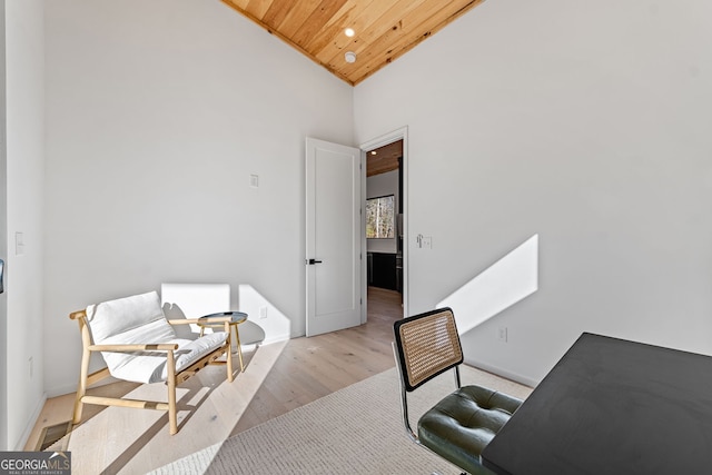 office area with light wood-type flooring, wooden ceiling, and high vaulted ceiling