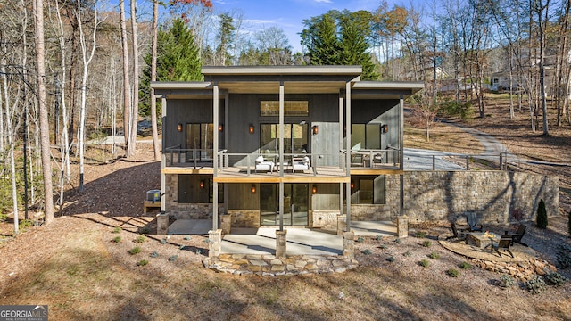 rear view of house with a patio area and a balcony