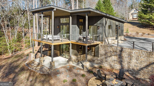 back of house with a patio and a deck