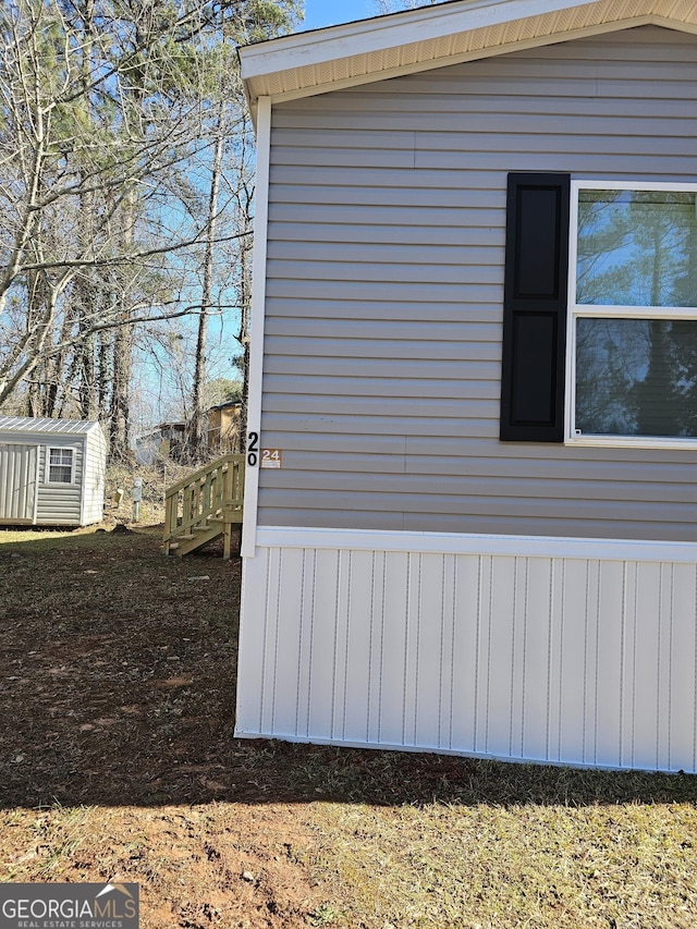 view of side of property with a storage unit