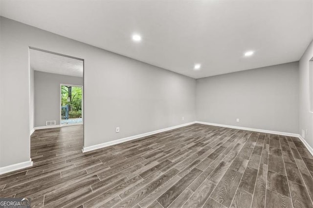 spare room with dark wood-type flooring