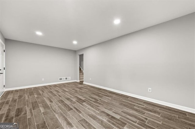 spare room with dark hardwood / wood-style floors