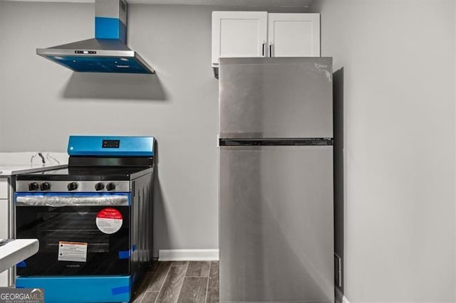 details featuring appliances with stainless steel finishes and exhaust hood