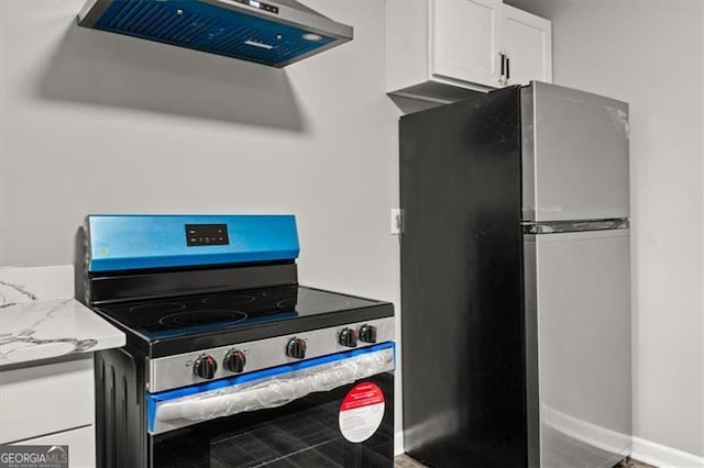 kitchen with light stone countertops, extractor fan, white cabinetry, and appliances with stainless steel finishes