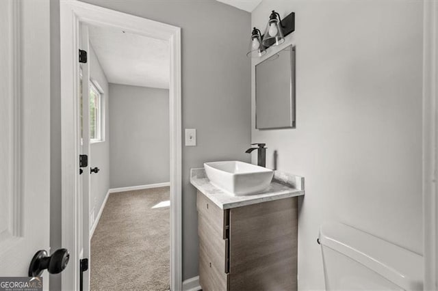 bathroom with toilet and vanity