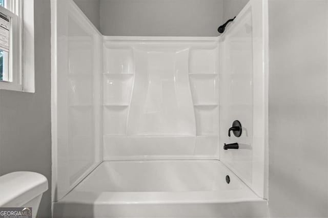 bathroom featuring toilet and shower / washtub combination