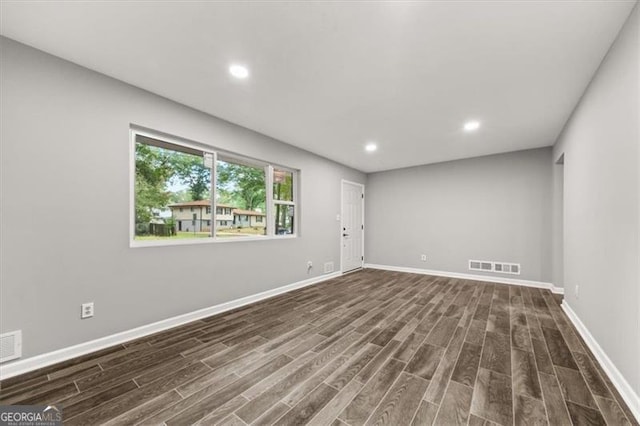 empty room featuring dark wood-type flooring