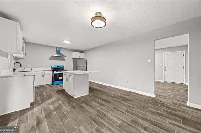 kitchen with white cabinets, stainless steel appliances, a center island, and a textured ceiling