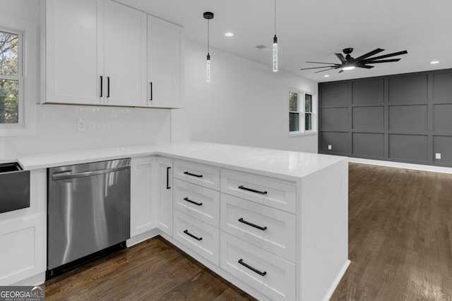 kitchen featuring stainless steel dishwasher, dark hardwood / wood-style flooring, white cabinetry, and hanging light fixtures