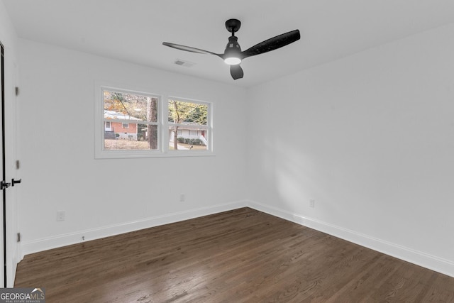 unfurnished room featuring ceiling fan and dark wood-type flooring