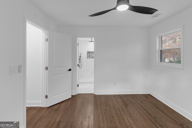 unfurnished room with ceiling fan and dark wood-type flooring