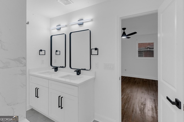 bathroom with hardwood / wood-style floors, ceiling fan, and vanity