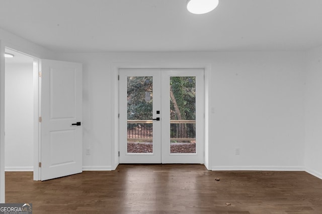 unfurnished room featuring french doors and dark hardwood / wood-style floors