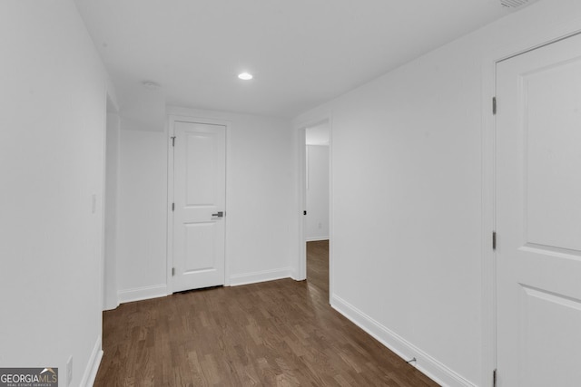 corridor with dark wood-type flooring