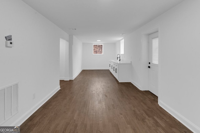 interior space with dark hardwood / wood-style floors and sink