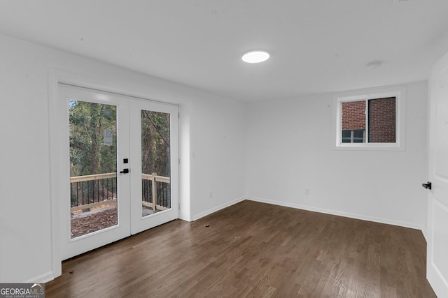 unfurnished room with dark hardwood / wood-style flooring and french doors