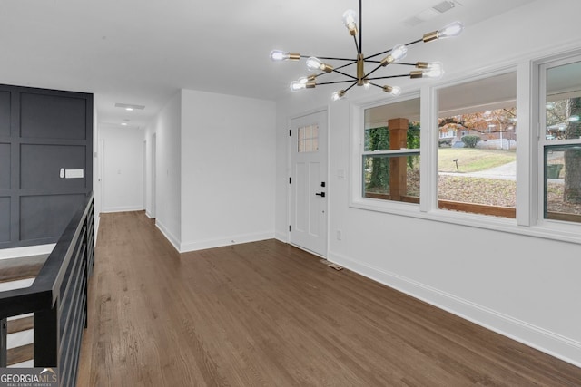 foyer featuring dark hardwood / wood-style floors and an inviting chandelier