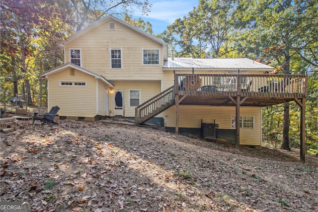 rear view of property featuring central air condition unit and a deck