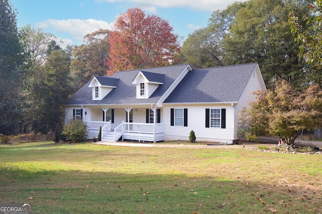 new england style home featuring covered porch and a front yard