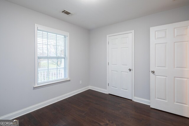 unfurnished bedroom featuring dark hardwood / wood-style floors