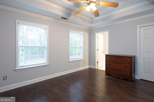 unfurnished bedroom with ornamental molding, a raised ceiling, ceiling fan, and dark wood-type flooring