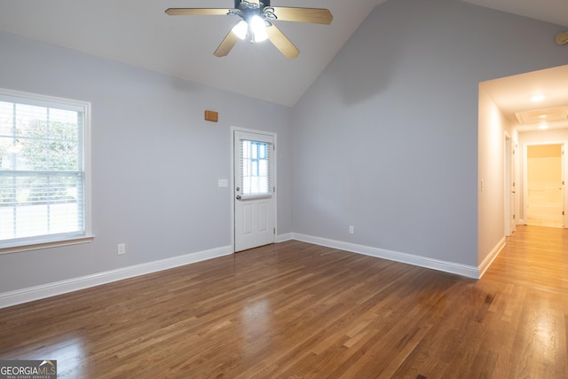 interior space with a wealth of natural light, lofted ceiling, and hardwood / wood-style flooring