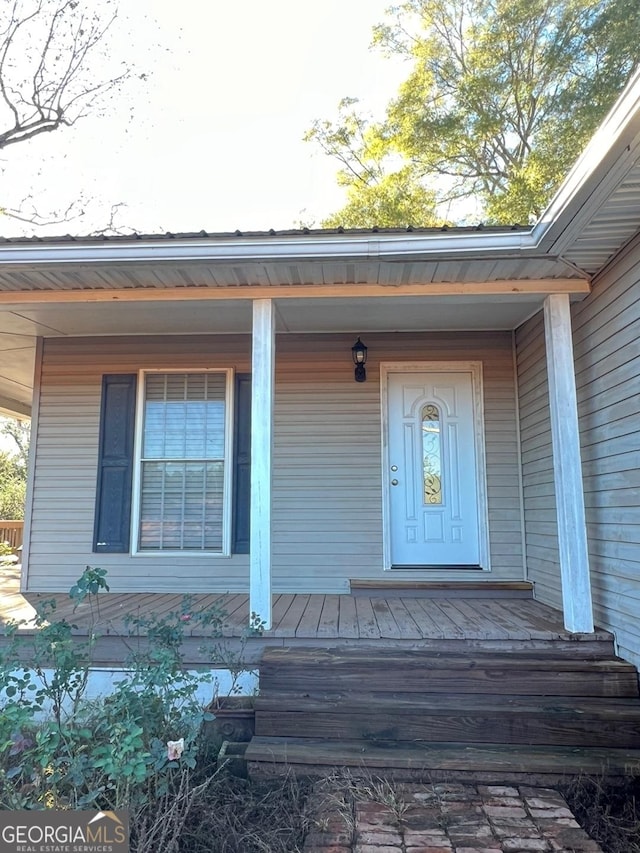 view of exterior entry with a porch