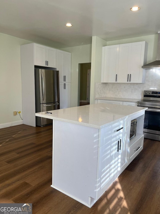 kitchen with dark hardwood / wood-style flooring, white cabinetry, and stainless steel appliances