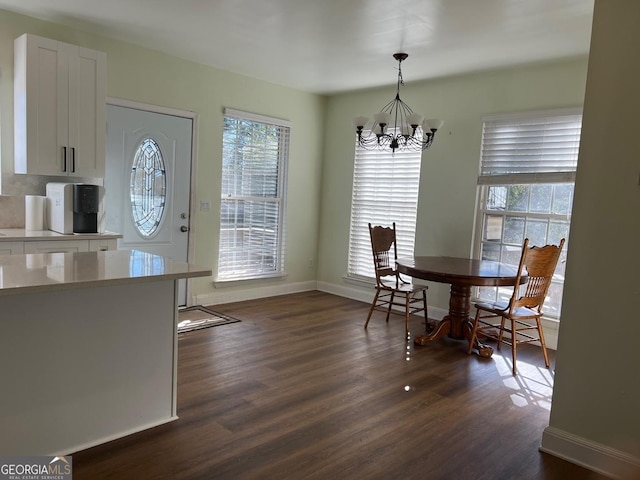 dining room featuring dark hardwood / wood-style flooring, a wealth of natural light, and a chandelier