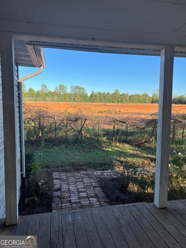 view of yard featuring a rural view and a deck