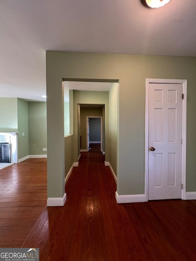 hallway with dark hardwood / wood-style floors