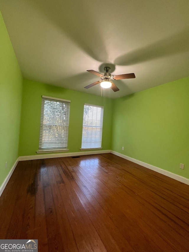 empty room featuring ceiling fan and wood-type flooring