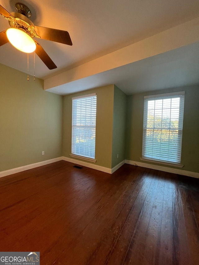 unfurnished room with ceiling fan and dark hardwood / wood-style floors